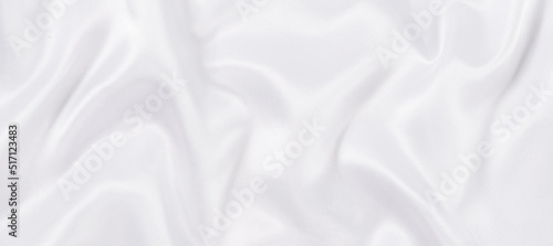 white silk fabric texture background. Cloth soft wave. Creases of satin