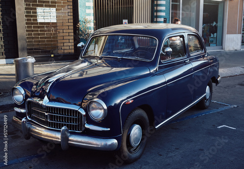 Italian Retro car parked in the old street of the European city. © Alessandro