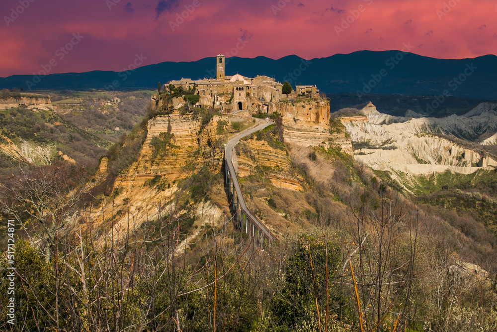 Fototapeta premium View of Civita di Bagnoregio during sunset, a picturesque hilltop village in Italy, is a popular day trip destination from Rome