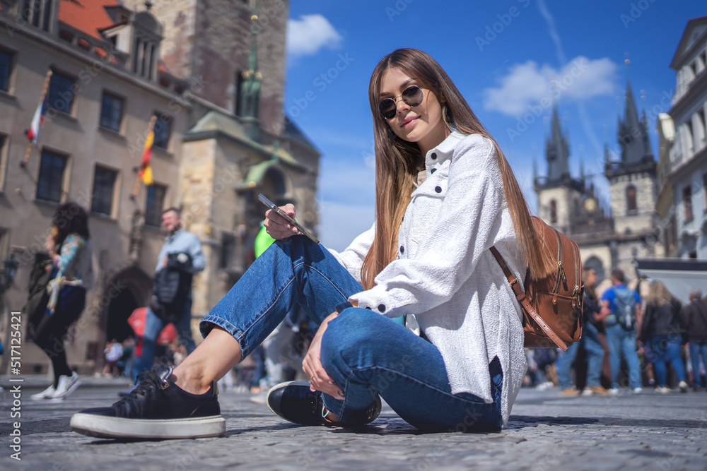 Stylish woman sitting on street