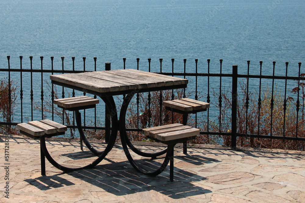 Empty table with four seats in a seaside park Empty table with four seats in a seaside park