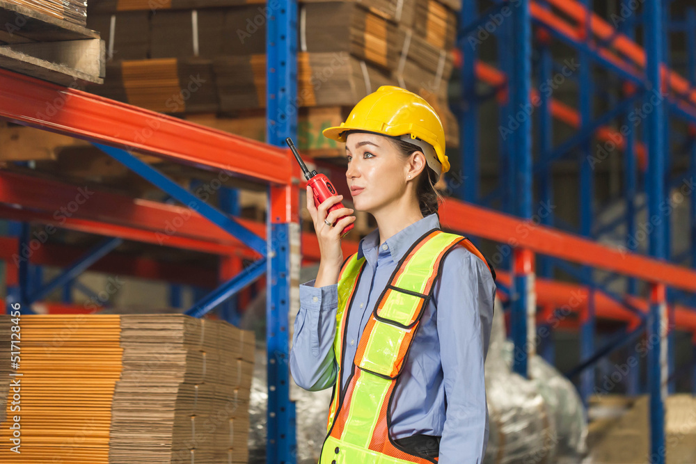 Warehouse worker working in factory warehouse industry and using radio talking communication, Foreman in hardhat safety vest with Two-Way radio working in logistics center Warehouse worker working in factory warehouse industry and using radio talking communication, Foreman in hardhat safety vest with Two-Way radio working in logistics center