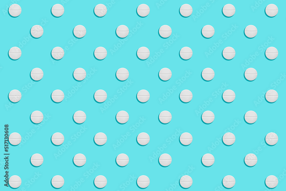 Pattern of white rounded shaped pills on a blue background