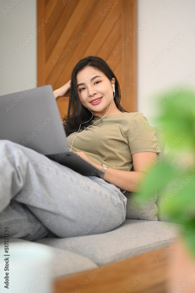 Young woman browsing internet, chatting with friends on laptop at home Young woman browsing internet, chatting with friends on laptop at home
