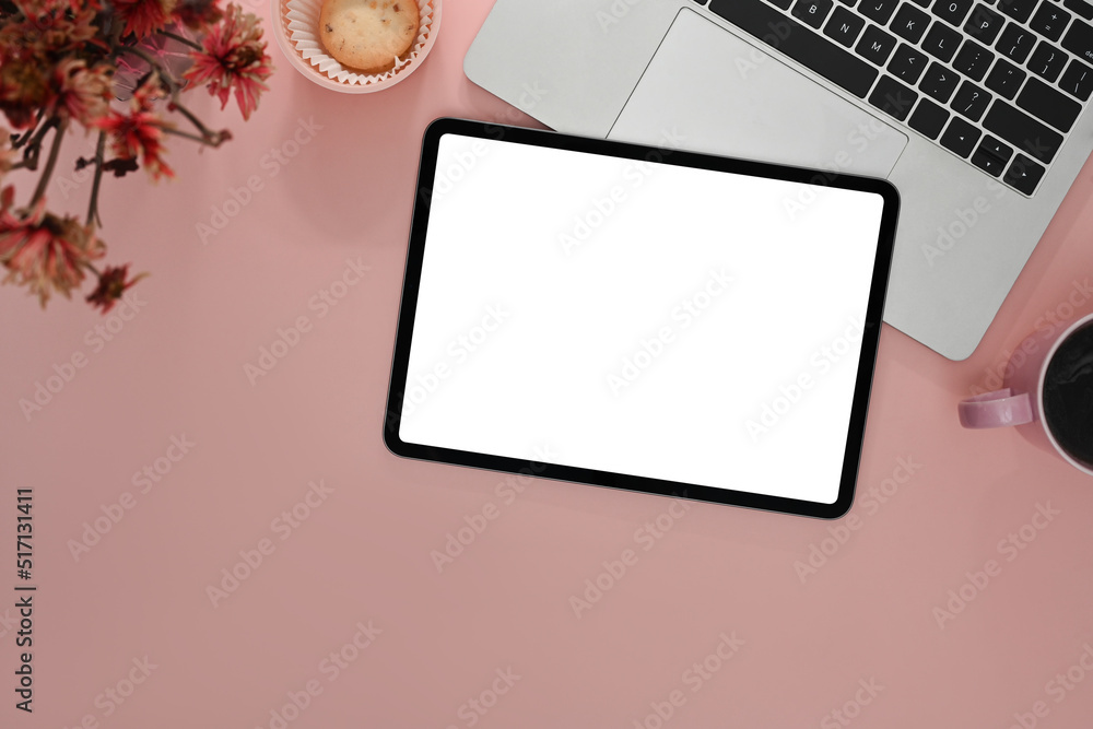 Top view digital tablet with empty screen, laptop, coffee cup and red flower on pink background Top view digital tablet with empty screen, laptop, coffee cup and red flower on pink background