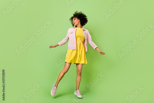 Full length portrait of excited cheerful lady enjoy free time freedom good mood isolated on green color background