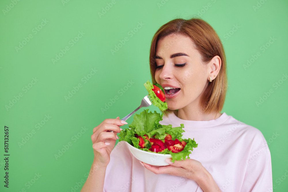 beautiful woman eating fresh vegetable salad on white background beautiful woman eating fresh vegetable salad on white background