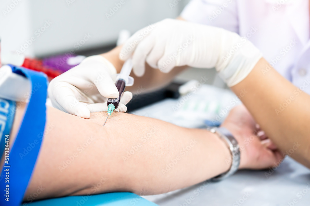Close up hand of nurse, taking blood sample from a patient in the hospital. Close up hand of nurse, taking blood sample from a patient in the hospital.