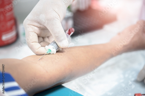 Close up hand of nurse, taking blood sample from a patient in the hospital.	