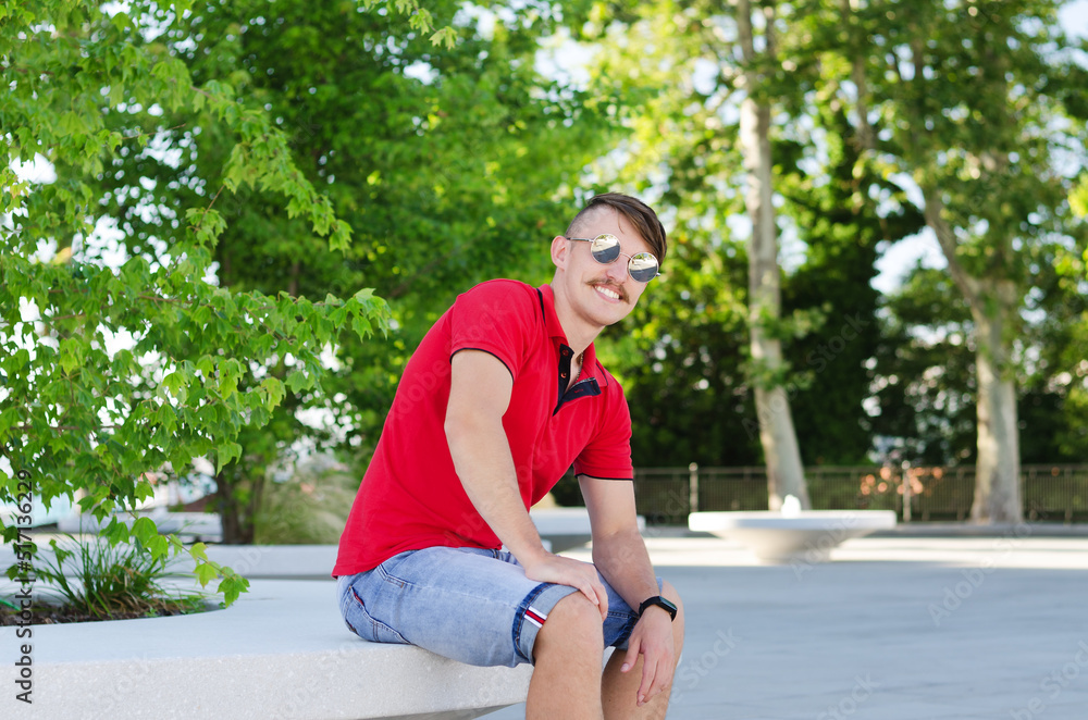 Young happy handsome bearded man, tourist walking in old city of Koper. Summer vacation. Sunglasses. Lifestyle portrait Young happy handsome bearded man, tourist walking in old city of Koper. Summer vacation. Sunglasses. Lifestyle portrait