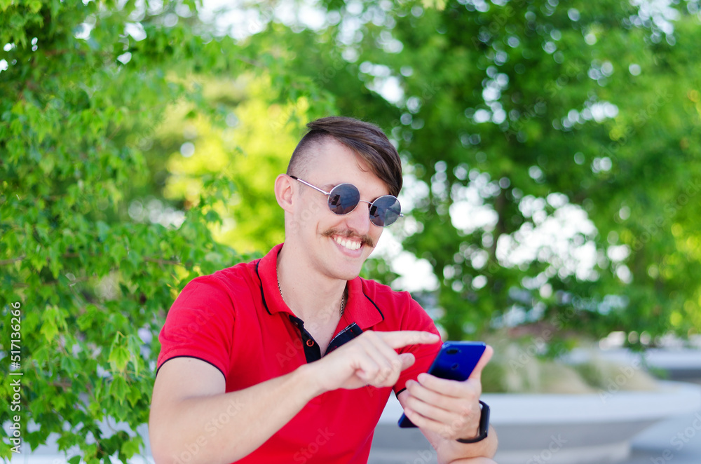 Young handsome man, tourist walking in summer park, old city. Phone call. Technology. Social media. Vacation Young handsome man, tourist walking in summer park, old city. Phone call. Technology. Social media. Vacation
