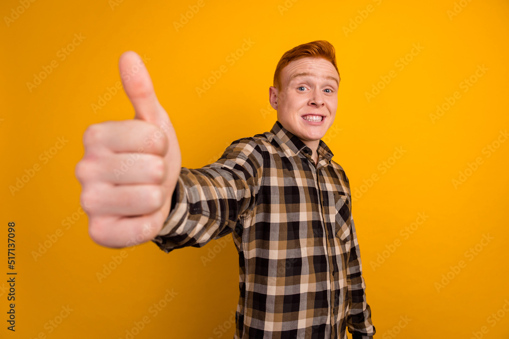 Photo of young cheerful man show thumb-up recommend feedback approve ads isolated over yellow color background Photo of young cheerful man show thumb-up recommend feedback approve ads isolated over yellow color background