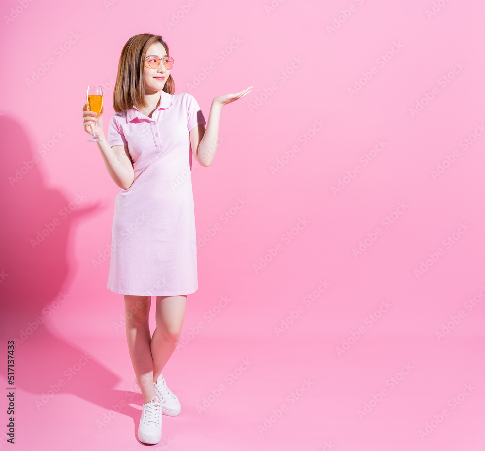 Full length photo of young Asian girl on pink background Full length photo of young Asian girl on pink background