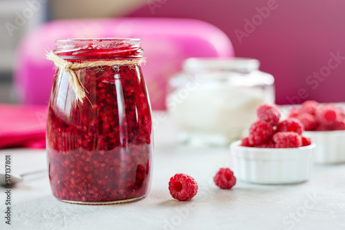 Raspberries with sugar. Homemade jam with fresh berry on the table, selective focus.