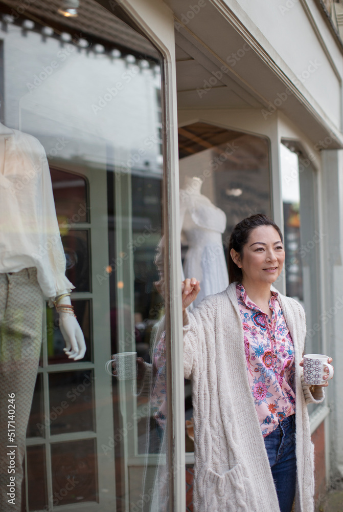 Lady Store Owner Confident female shop owner drinking tea outside boutique Stock Photo ...
