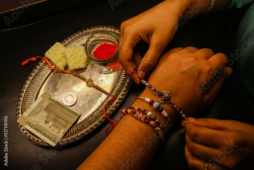 Brother sister love bond sister tying rakhi on brother's hand with shagun and rakhi thali Indian festival photo