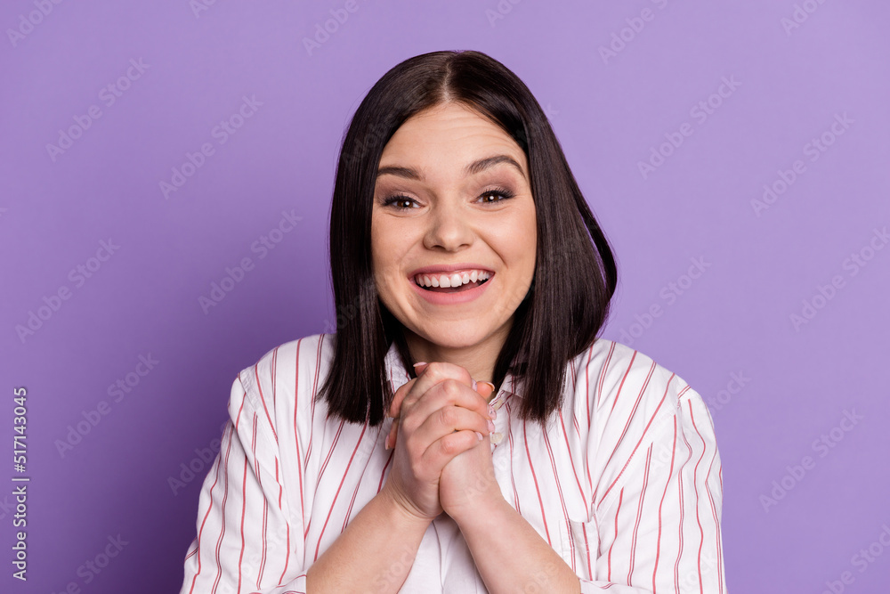 Photo of young excited pretty girl hands together glad gift waiting isolated over violet color background Photo of young excited pretty girl hands together glad gift waiting isolated over violet color background