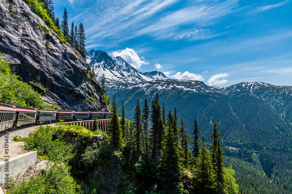A view looking back from a train on the White Pass and Yukon railway on a bridge near Skagway, Alaska in summertime