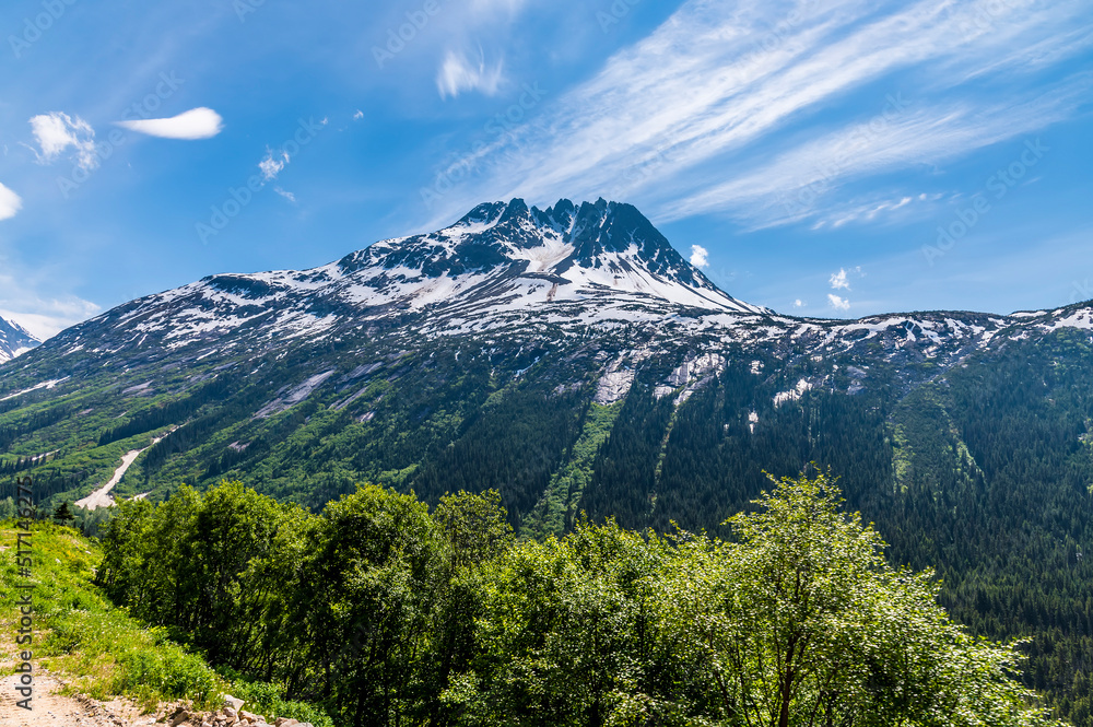 A view of mountain scenery from a train on the White Pass and Yukon railway near Skagway, Alaska in summertime