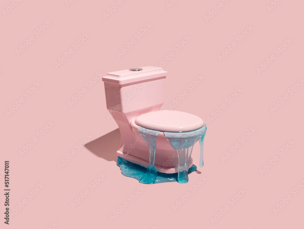 Pastel pink toilet bowl and blue liquid, creative arrangement. Blue