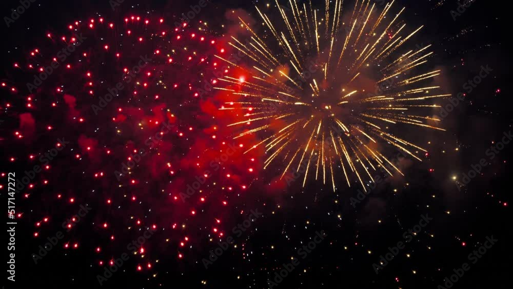 Volleys of fireworks in the sky above the city. Colorful of fireworks for 4th July national holiday festival, independence day concept Volleys of fireworks in the sky above the city. Colorful of fireworks for 4th July national holiday festival, independence day concept
