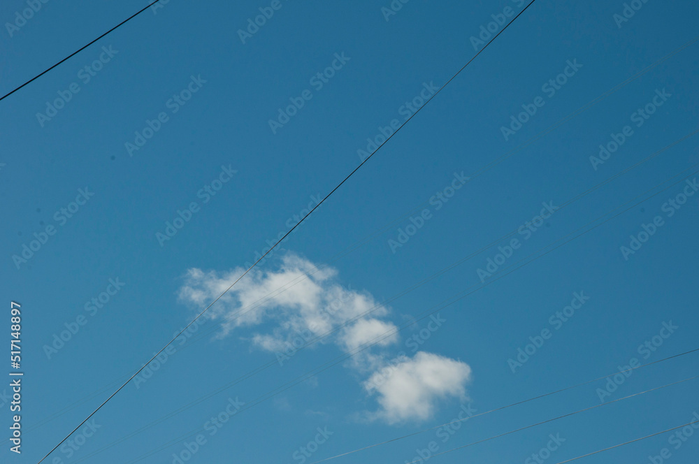 Wires in cloudy blue sky background, copy space Wires in cloudy blue sky background, copy space