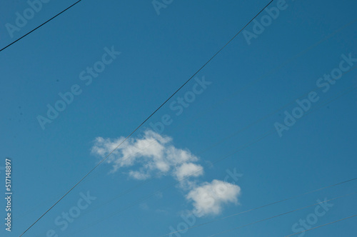 Wires in cloudy blue sky background, copy space