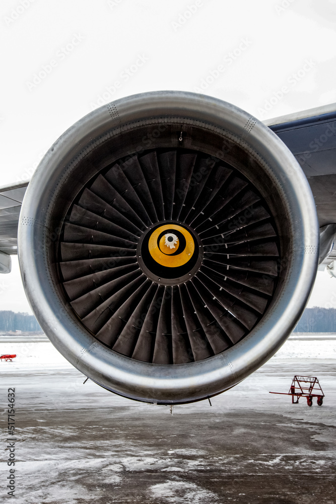 Airplane engine with aircraft wing on runway of airfield Airplane engine with aircraft wing on runway of airfield