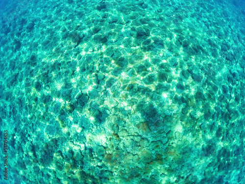 Top view of colorful azure water with stones and sea water top view background.