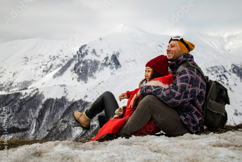 young couple in love enjoying on winter vacation together on the mountain