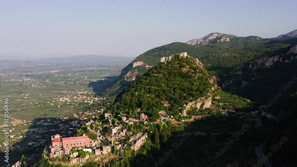 Drone shot of medieval old city of Mystras with Monastery of Pantanassa, Temple of Agia Sofia and uphill castle of Mystras, Sparta, Peloponnese, Greece Drone shot of medieval old city of Mystras with Monastery of Pantanassa, Temple of Agia Sofia and uphill castle of Mystras, Sparta, Peloponnese, Greece