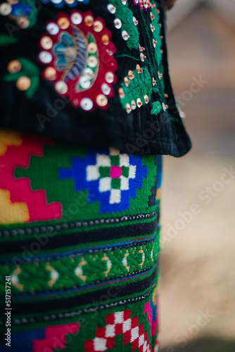 Part of Ukrainian traditional costume closeup: skirt with colorful ornament, velvet pot embroidered with flowers with sequins and beads. Culture of Ukraine 