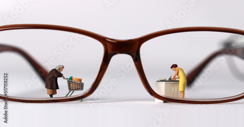 Business concept with glasses and miniature people. 