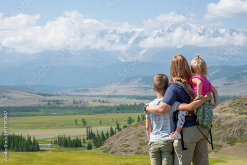 Happy family looking at mountain. Concept of friendly family at travel. Altai Republic. Siberia. Russia. Empty space for text photo