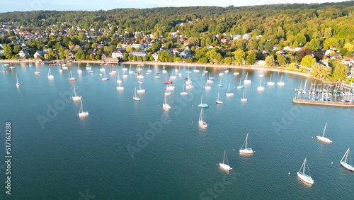 Boats tied up at lake. Sailboats anchor in harbor. Aerial view flying drone of town Herrsching at Ammersee lake, popular excursion and recreation place near munich in bavaria, germany photo