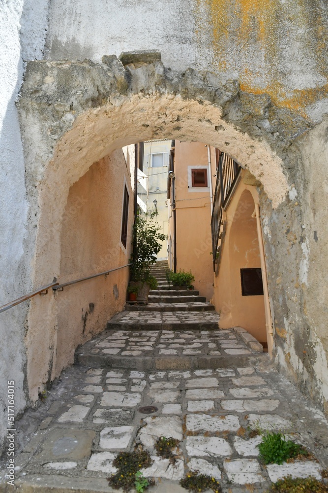 A street between the old houses of Tricarico, a rural village in the Basilicata region, Italy.