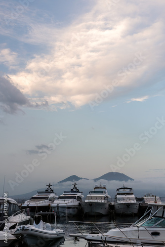 Luxury boats in harbor on a summer evening with Mount Vesuvius in the background  Naples  Italy