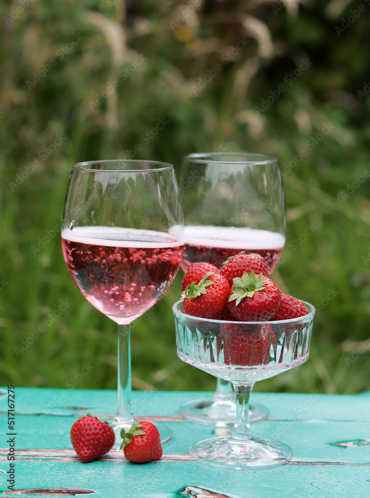 Romantic date in a park. Glasses with cocktails on a table. Refreshment concept. Romantic date in a park. Glasses with cocktails on a table. Refreshment concept.