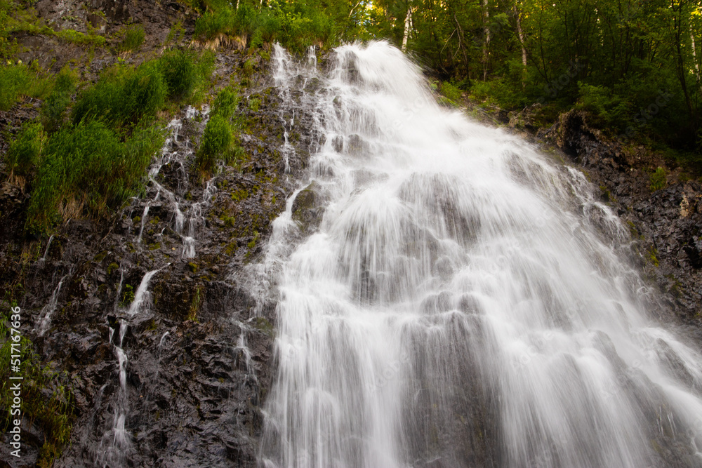 Fototapeta premium Waterfall flowing inside the rainforest area.