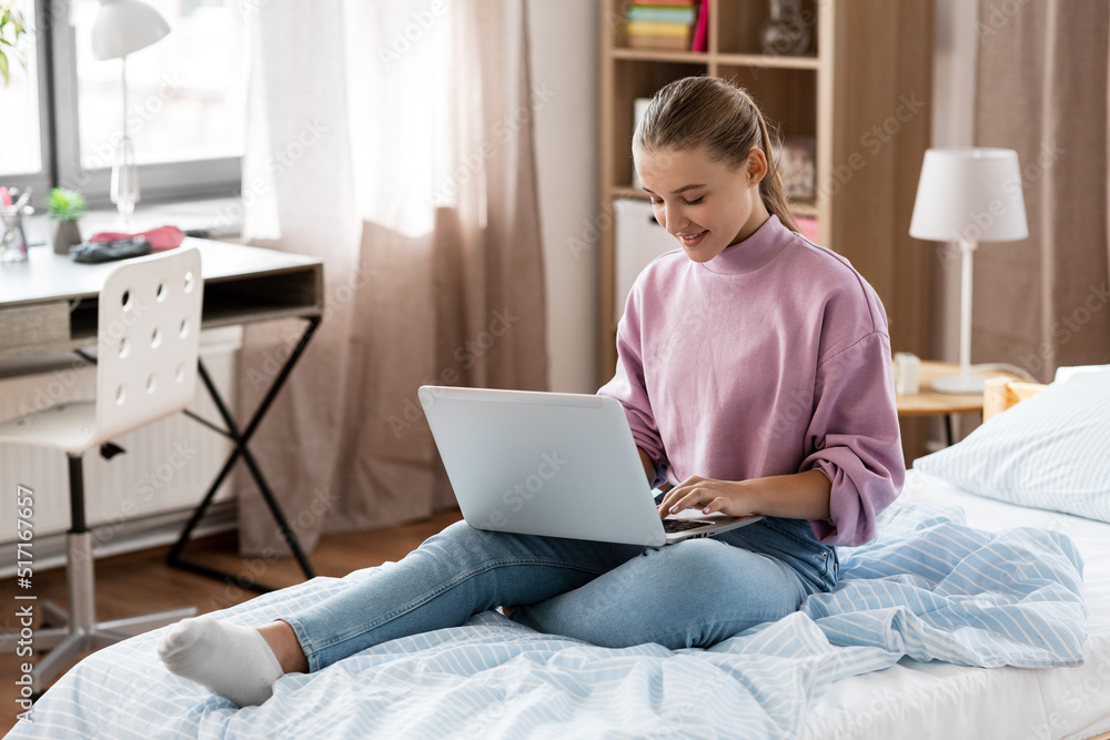 children, education and learning concept - happy smiling student girl with laptop computer at home children, education and learning concept - happy smiling student girl with laptop computer at home