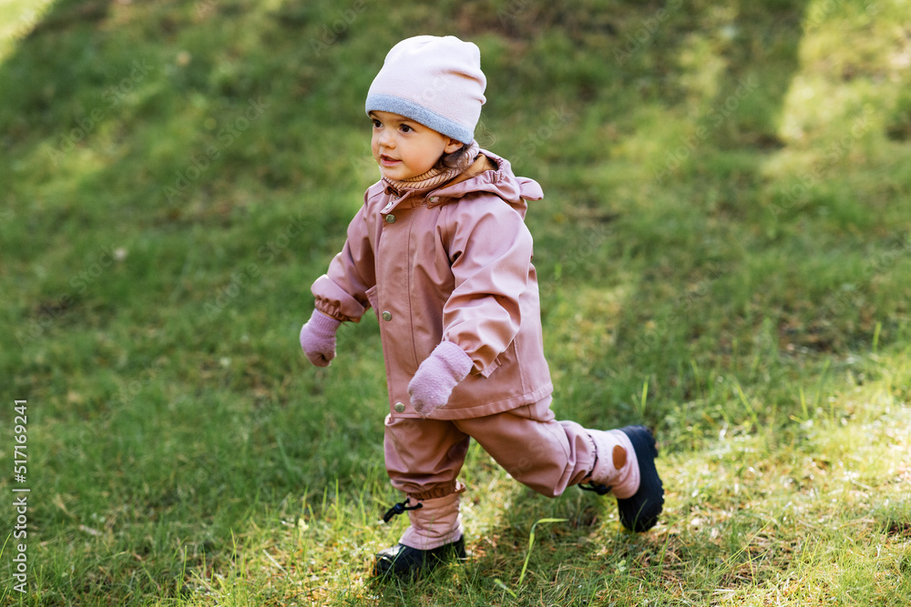 childhood, leisure and season concept - happy little baby girl walking in autumn park