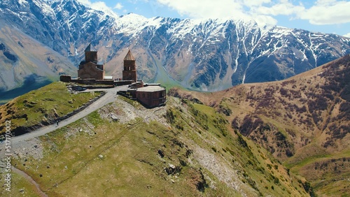 beautiful view of ancient Gergeti Trinity Church in Kazbegi, Georgia. snow-capped Caucasus mountains in the background. High quality photo