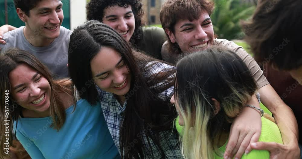Young group of friends having fun outdoor with university on background Young group of friends having fun outdoor with university on background