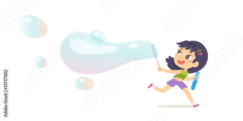 Child blowing soap bubble and running, happy little girl holding maker to blow balloon