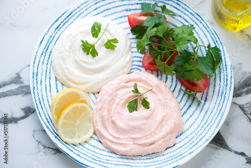 Middle close-up of greek fish roe salad or taramasalata served on a blue and white plate, horizontal shot photo