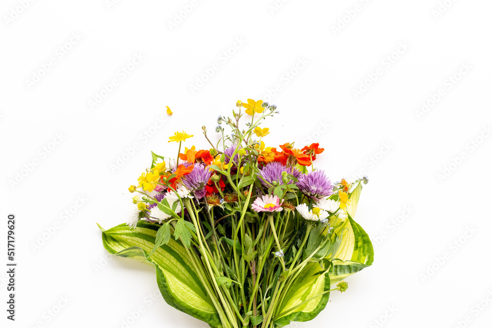 Fototapeta premium Bunch of wild meadow flowers and herbs chamomile, cornflower and ranunculus. Summer floral background