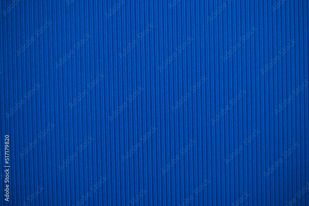Abstract background made of corrugated paper for blue application. Space for text. Texture. Vertical stripes. Abstract background made of corrugated paper for blue application. Space for text. Texture. Vertical stripes.