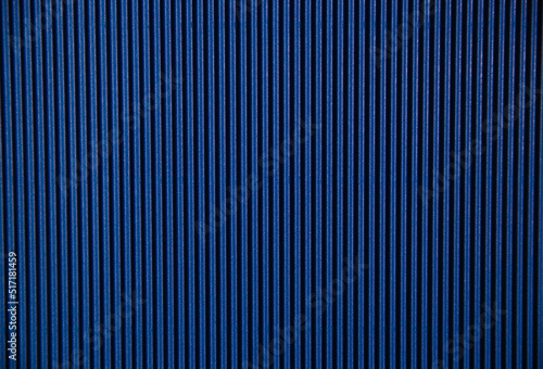 Abstract background made of corrugated paper for blue application. Space for text. Texture. Vertical stripes.
