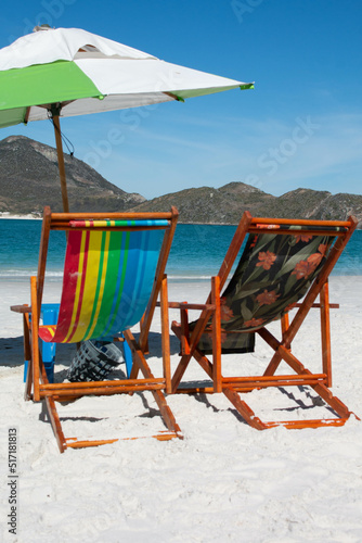 Colorful sun loungers with umbrellas on the incredible beach of Pontal do Atalaia  Cabo Frio  Brazil.  