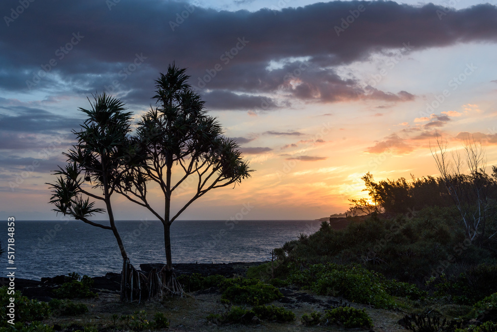 Beautiful, tropical sunset at La Reunion, sun over the sea with orange sky